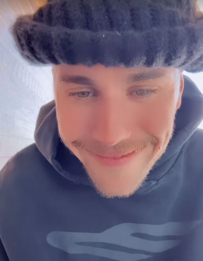 Man in a black beanie and hoodie, smiling gently. Man in a black beanie and hoodie, smiling gently.