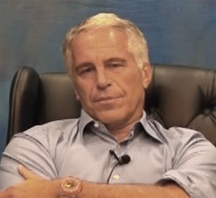 A man in a blue shirt sits in an office chair, associated with secret documents and celebrity names. A man in a blue shirt sits in an office chair, associated with secret documents and celebrity names.