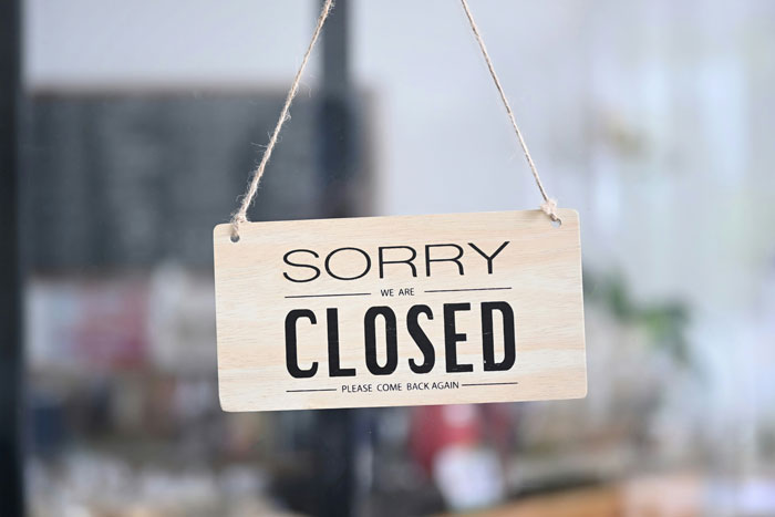 Closed sign hanging on a door, related to Joann fabric and craft retailer store closures announcement. Closed sign hanging on a door, related to Joann fabric and craft retailer store closures announcement.