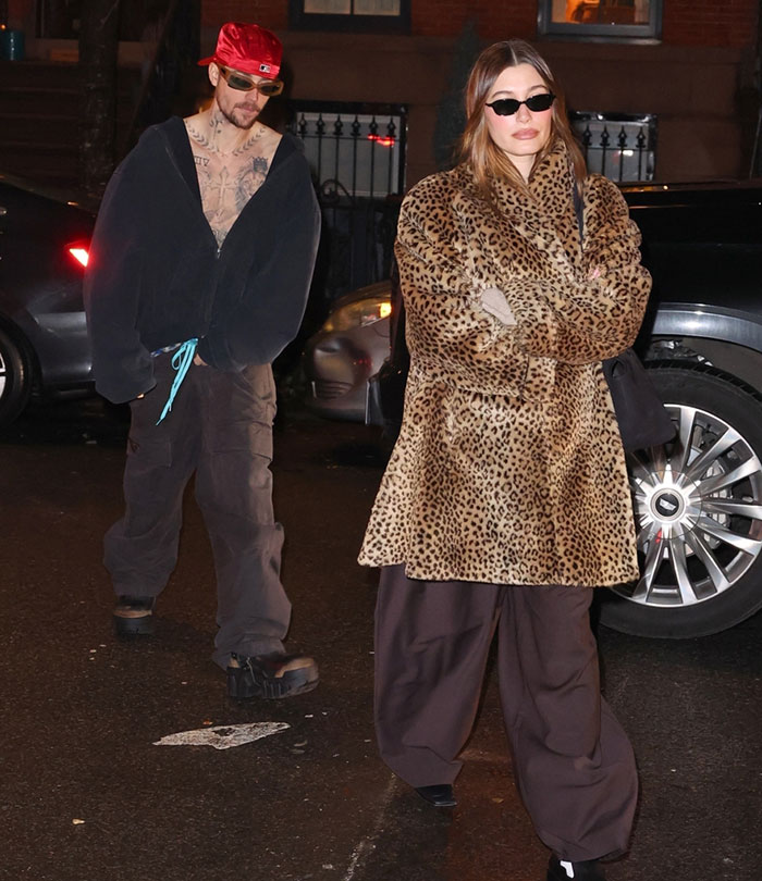 Person in Brooklyn wearing casual clothes, followed by someone in a leopard coat, emphasizing health concerns. Person in Brooklyn wearing casual clothes, followed by someone in a leopard coat, emphasizing health concerns.