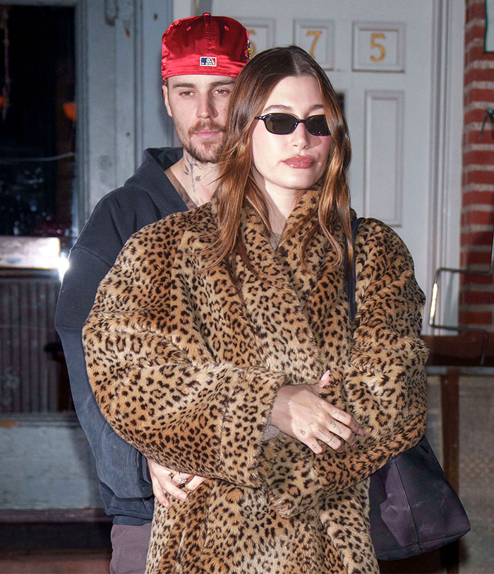 A person in a leopard print coat and sunglasses, standing in front of another wearing a red cap; addressing substance abuse rumors. A person in a leopard print coat and sunglasses, standing in front of another wearing a red cap; addressing substance abuse rumors.