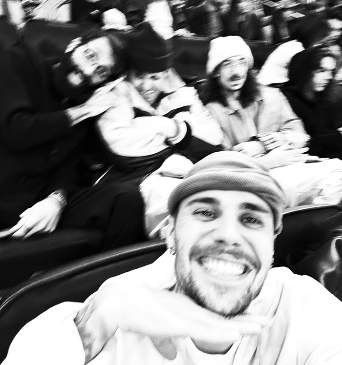 Smiling person in a selfie with friends, wearing casual beanies and jackets, capturing a cheerful moment together. Smiling person in a selfie with friends, wearing casual beanies and jackets, capturing a cheerful moment together.