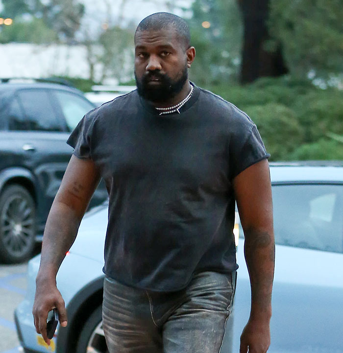 A person in a black shirt outside near parked cars, related to Bianca Censori's afterparty song discussion. A person in a black shirt outside near parked cars, related to Bianca Censori's afterparty song discussion.