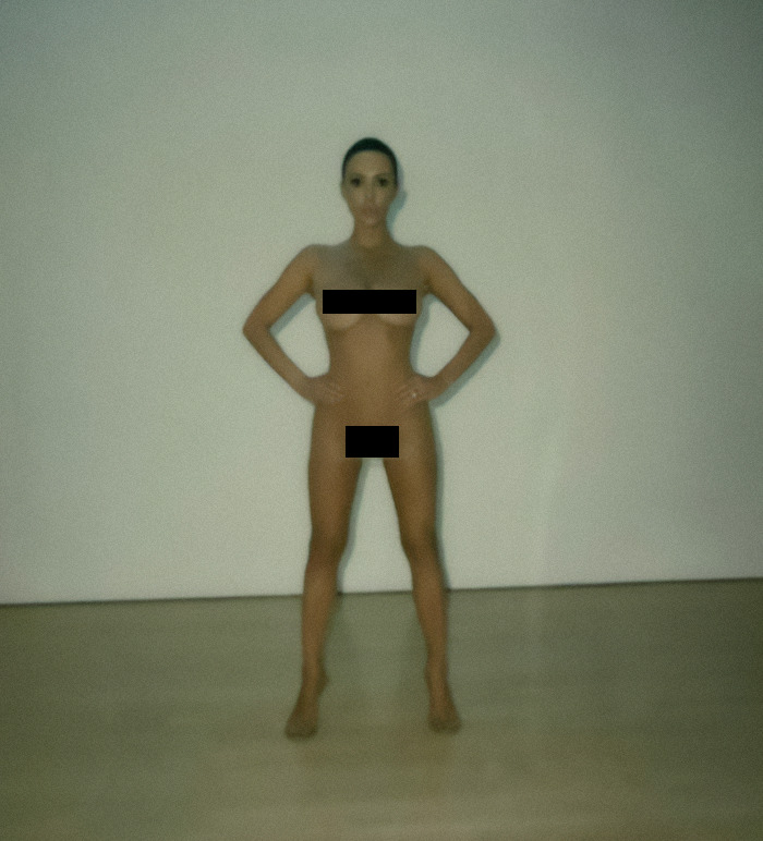 Bianca Censori posing in front of a white wall indoors. Bianca Censori posing in front of a white wall indoors.