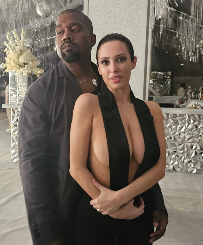 Bianca Censori and Kanye West posing together at a formal event. Bianca Censori and Kanye West posing together at a formal event.