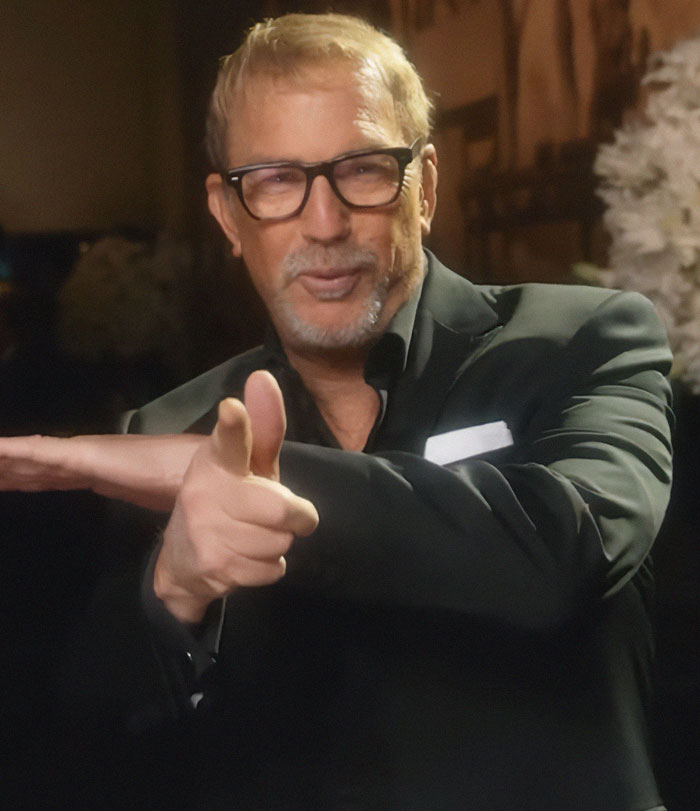 Man in glasses and a suit gesturing humorously, embodying a viral reaction to a joke on a comedy show. Man in glasses and a suit gesturing humorously, embodying a viral reaction to a joke on a comedy show.