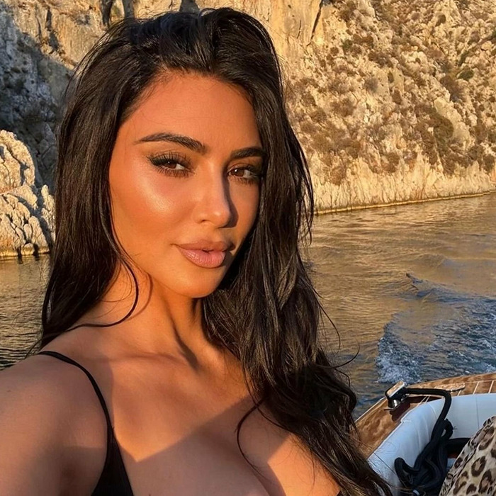 Kim Kardashian posing for a selfie outdoors. Kim Kardashian posing for a selfie outdoors.