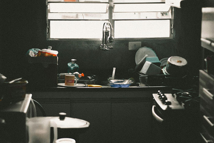 Cluttered kitchen sink with dirty dishes, highlighting neglecting chores and household responsibilities. Cluttered kitchen sink with dirty dishes, highlighting neglecting chores and household responsibilities.