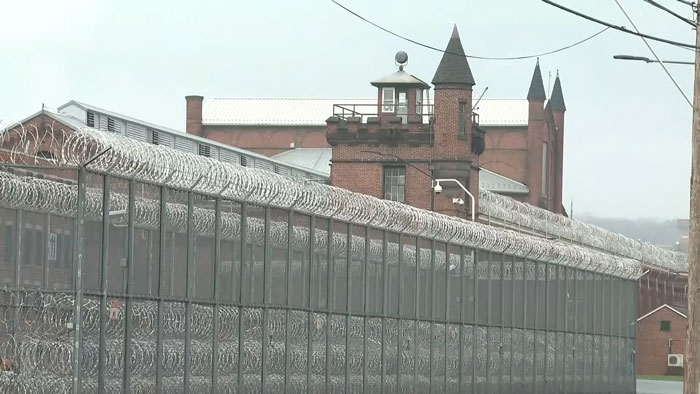 Prison exterior with barbed wire fences, relating to Luigi Mangione's public statement reaction. Prison exterior with barbed wire fences, relating to Luigi Mangione's public statement reaction.