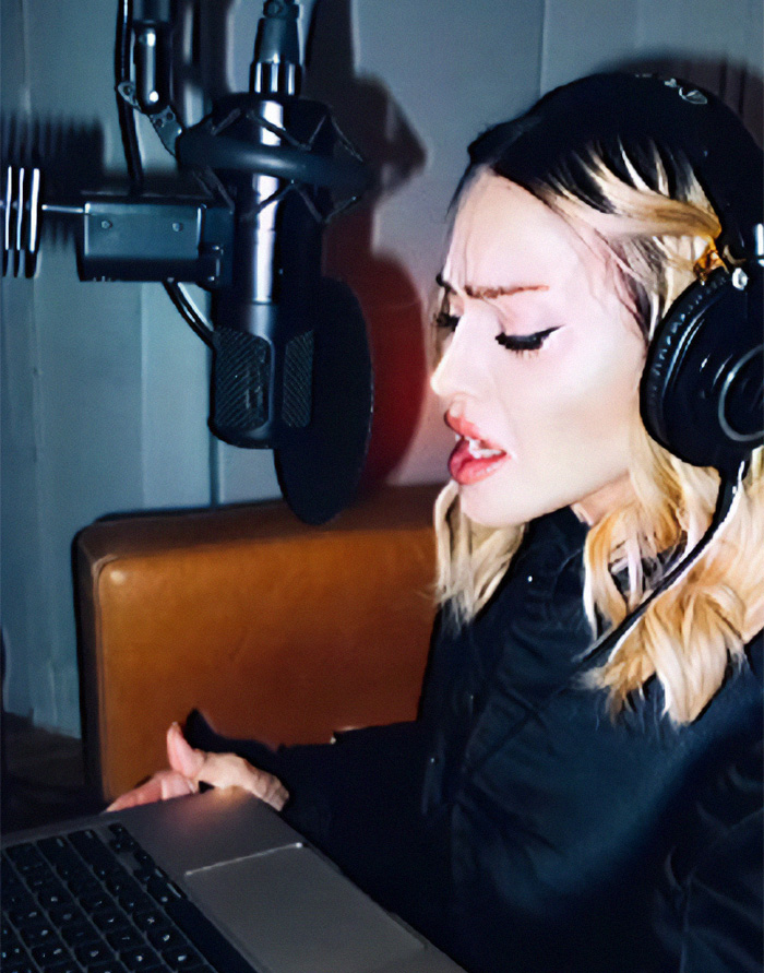 Person recording in a studio with headphones and a microphone Person recording in a studio with headphones and a microphone