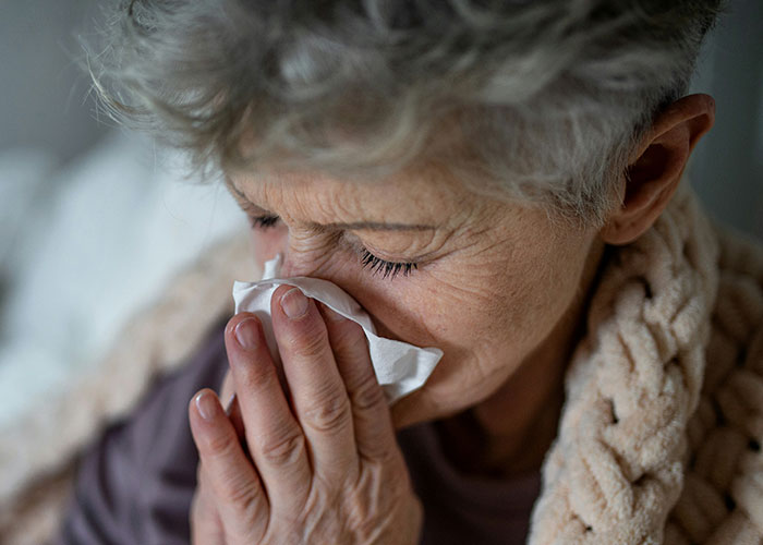 Elderly woman crying, covering face, upset over son's girlfriend's house rule. Elderly woman crying, covering face, upset over son's girlfriend's house rule.