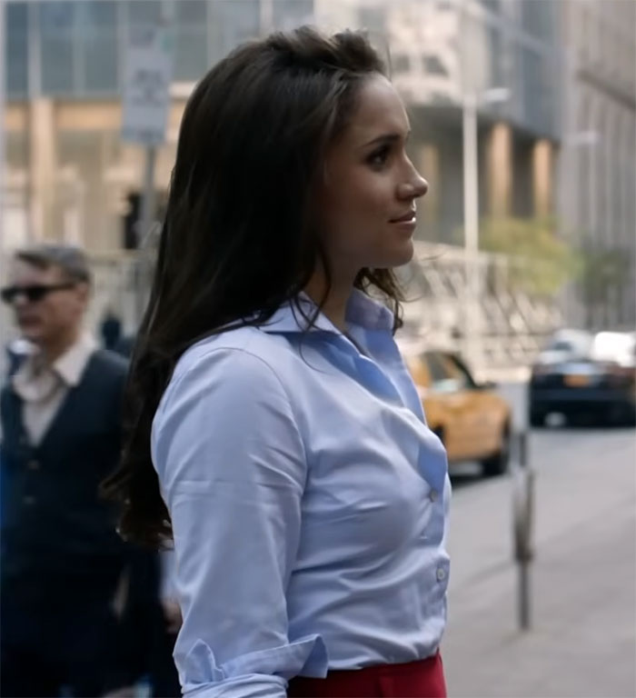 Person in blue shirt on a city street with blurred taxis in the background. Person in blue shirt on a city street with blurred taxis in the background.