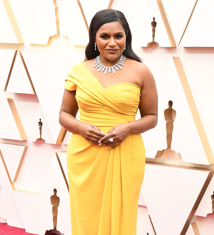 Mindy Kaling in a stunning yellow dress at a movie premiere, highlighting her slim figure. Mindy Kaling in a stunning yellow dress at a movie premiere, highlighting her slim figure.