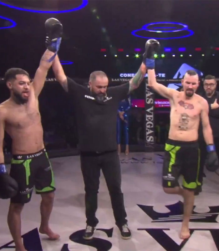 Two pro MMA fighters celebrating victory in a controversial fight, with a referee raising their hands. Two pro MMA fighters celebrating victory in a controversial fight, with a referee raising their hands.