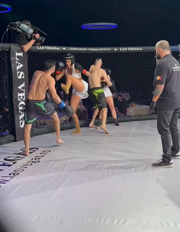 Controversial MMA fight with two pro men and three women in a ring, surrounded by a referee and cameraman. Controversial MMA fight with two pro men and three women in a ring, surrounded by a referee and cameraman.