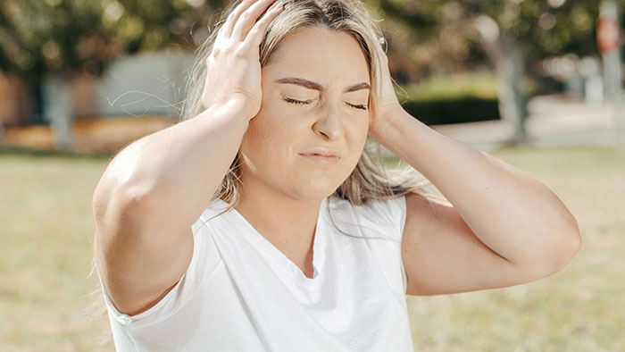 Woman outdoors looking frustrated over unauthorized car parking by neighbor. Woman outdoors looking frustrated over unauthorized car parking by neighbor.