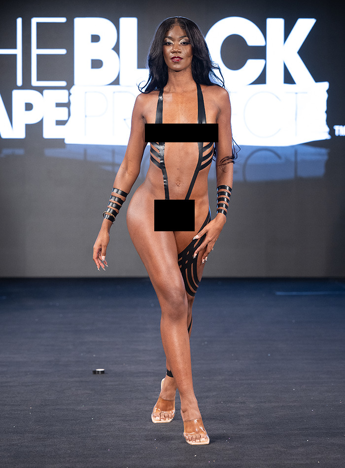 Model at New York Fashion Week wearing tape design on runway. Model at New York Fashion Week wearing tape design on runway.