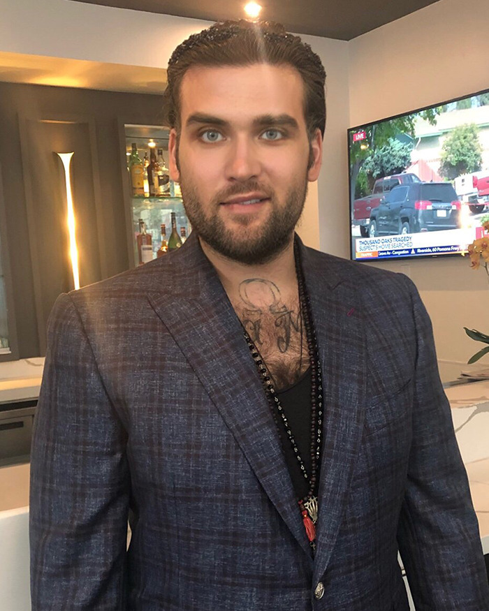 Nicolas Cage and Christina Fulton's son Weston Coppola Cage in a suit standing indoors beside a TV. Nicolas Cage and Christina Fulton's son Weston Coppola Cage in a suit standing indoors beside a TV.