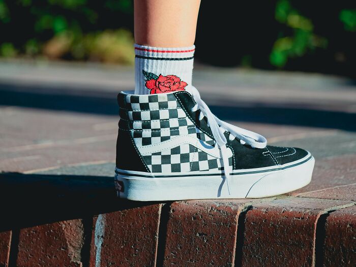 Checkered sneakers and floral socks, a look from recent fashion trends people hate.