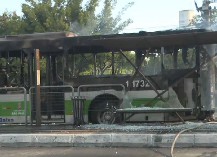 Burnt bus on the street following an aviation disaster, with visible damage and smoke. Burnt bus on the street following an aviation disaster, with visible damage and smoke.