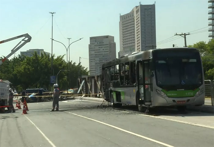 Bus damaged in aviation disaster, cordoned off on city street with surrounding skyscrapers. Bus damaged in aviation disaster, cordoned off on city street with surrounding skyscrapers.