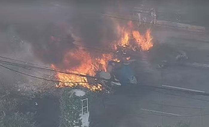 Burning wreckage from a plane crash into a bus in a latest aviation disaster on a city street. Burning wreckage from a plane crash into a bus in a latest aviation disaster on a city street.