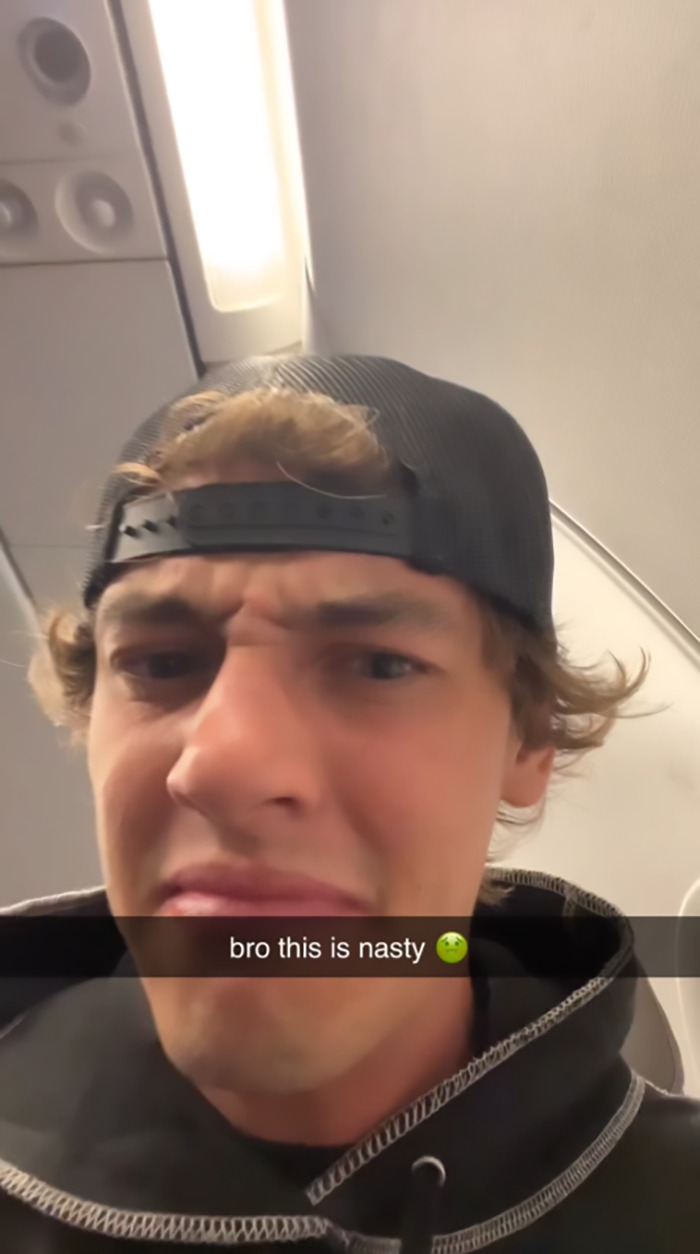 Passenger reacting to bare feet in personal space, expressing disgust with "bro this is nasty" caption in an airplane setting. Passenger reacting to bare feet in personal space, expressing disgust with "bro this is nasty" caption in an airplane setting.