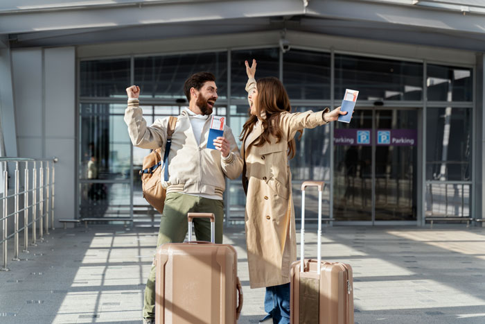 A couple at the airport with luggage and boarding passes, excited for their travel adventure. A couple at the airport with luggage and boarding passes, excited for their travel adventure.