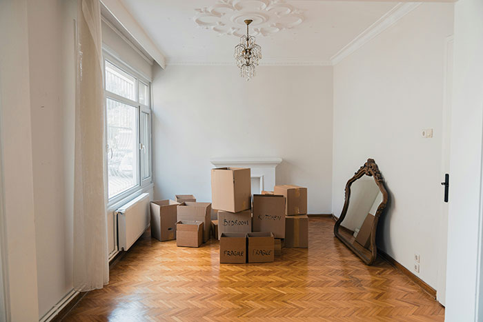 Empty room with moving boxes and mirror, symbolizing rent payment struggles involving dad’s ex-wife and son. Empty room with moving boxes and mirror, symbolizing rent payment struggles involving dad’s ex-wife and son.