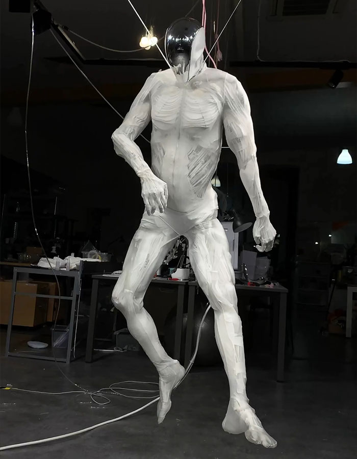 Humanoid robot with lifelike muscles suspended in a workshop environment, showcasing advanced robotics technology. Humanoid robot with lifelike muscles suspended in a workshop environment, showcasing advanced robotics technology.