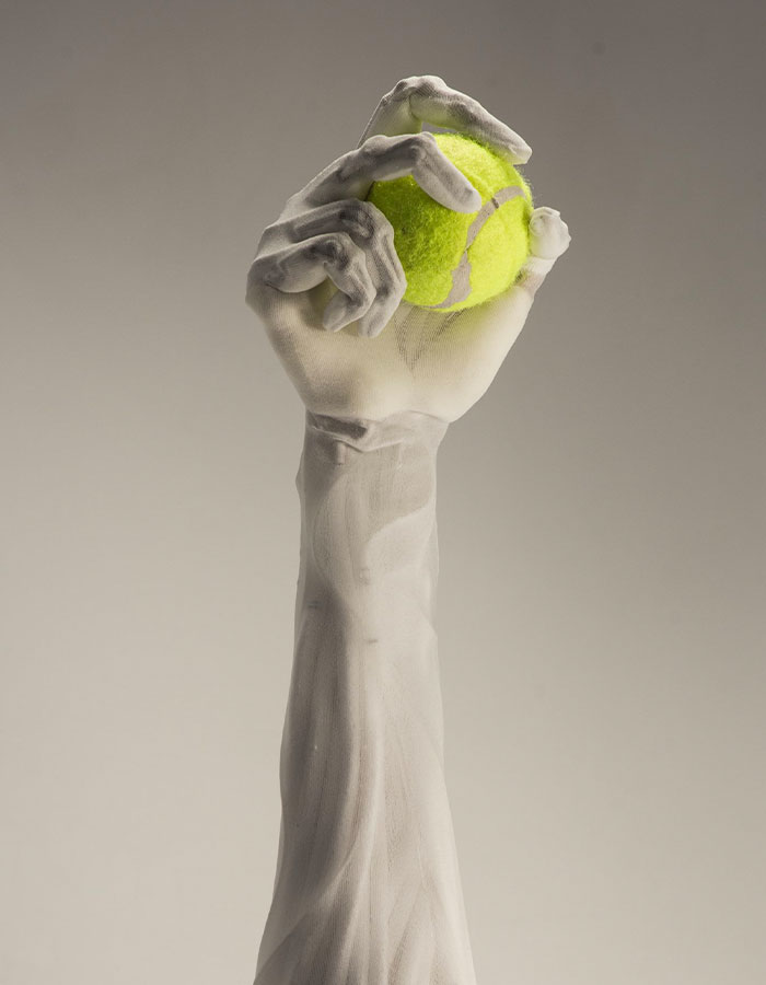 Humanoid robot arm with lifelike muscles holding a tennis ball, showcasing advanced robotics technology. Humanoid robot arm with lifelike muscles holding a tennis ball, showcasing advanced robotics technology.
