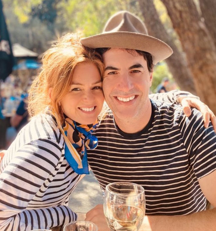 Couple smiling outdoors in striped tops, enjoying a sunny day with glasses of wine, hinting at a past relationship. Couple smiling outdoors in striped tops, enjoying a sunny day with glasses of wine, hinting at a past relationship.