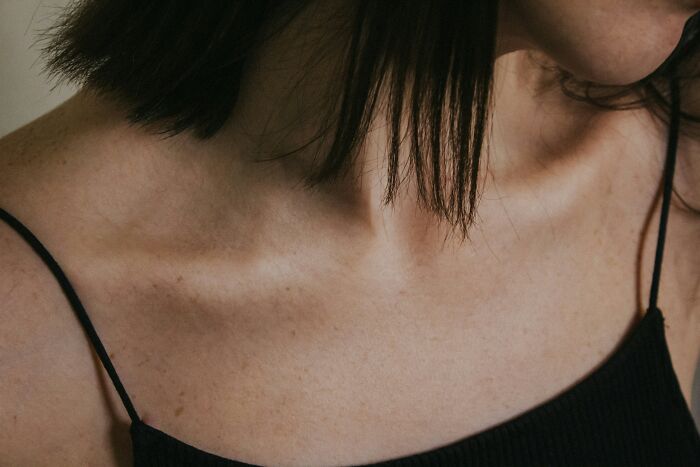 Close-up of a person's collarbone and shoulder, highlighting genetic blessings and weaknesses.