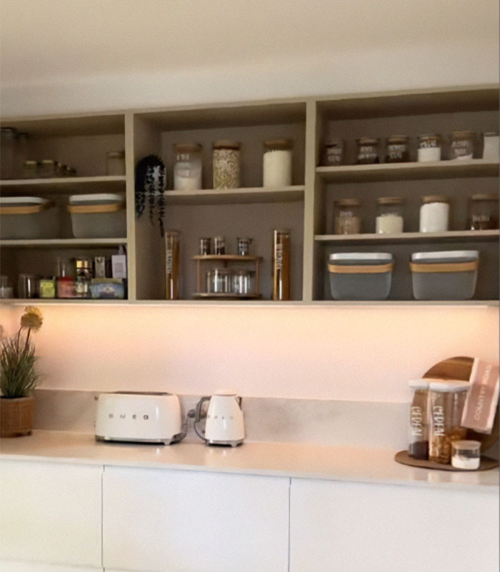 Kitchen transformation with neatly organized shelves and modern appliances. Kitchen transformation with neatly organized shelves and modern appliances.