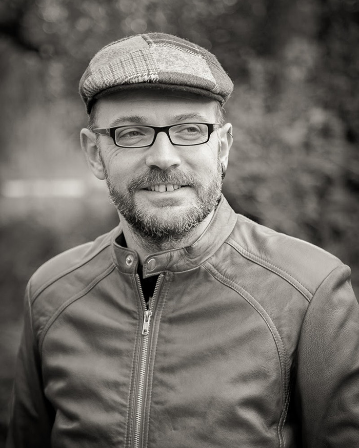 Dr. Cédric Sueur outdoors wearing a cap and glasses, dressed in a leather jacket, smiling. Dr. Cédric Sueur outdoors wearing a cap and glasses, dressed in a leather jacket, smiling.