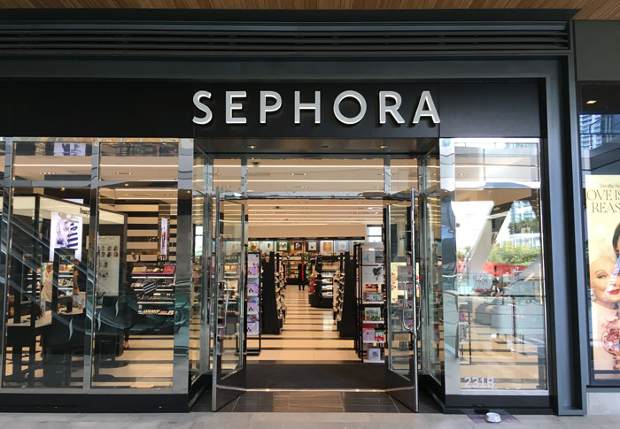 Sephora store entrance with displays of beauty products inside, showcasing the brand's offerings. Sephora store entrance with displays of beauty products inside, showcasing the brand's offerings.