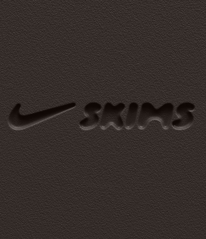 Logo of Nike and Skims collaboration on a textured dark background. Logo of Nike and Skims collaboration on a textured dark background.