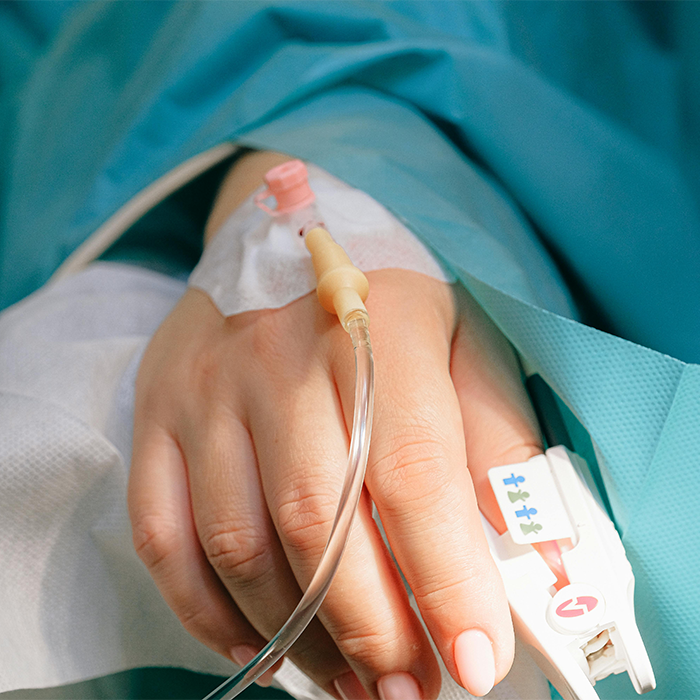 Hand with IV line, representing Covid vaccines linked to new syndrome discovered by scientists. Hand with IV line, representing Covid vaccines linked to new syndrome discovered by scientists.