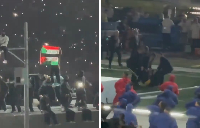 Super Bowl halftime show dancer holds flag, causing a stir during performance. Super Bowl halftime show dancer holds flag, causing a stir during performance.