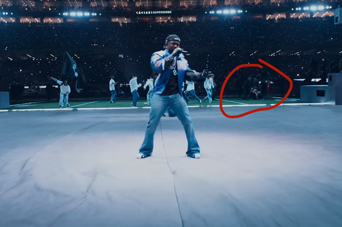 Super Bowl halftime stage with dancer highlighted for flag stunt during performance. Super Bowl halftime stage with dancer highlighted for flag stunt during performance.
