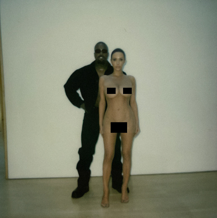 Bianca Censori and Kanye West posing for a photo in front of a plain wall indoors. Bianca Censori and Kanye West posing for a photo in front of a plain wall indoors.