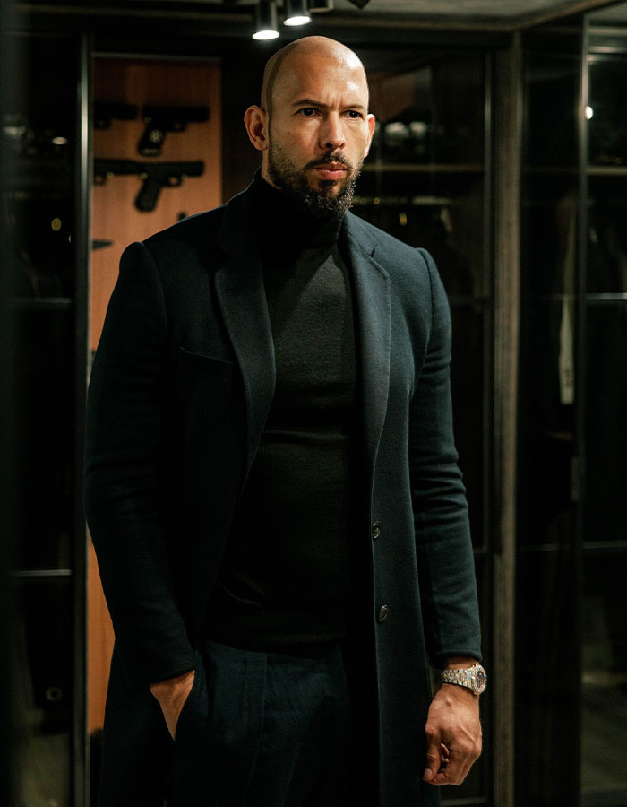 Man in dark clothing standing indoors, related to deportation and trafficking charges. Man in dark clothing standing indoors, related to deportation and trafficking charges.