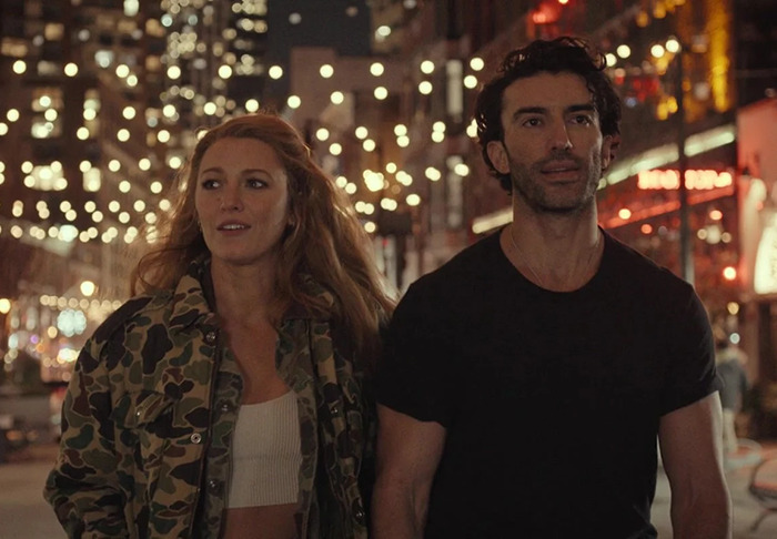 Justin Baldoni and Blake Lively walking through city lights at night, both casually dressed, and looking ahead from 'It Ends With Us'. Justin Baldoni and Blake Lively walking through city lights at night, both casually dressed, and looking ahead from 'It Ends With Us'.