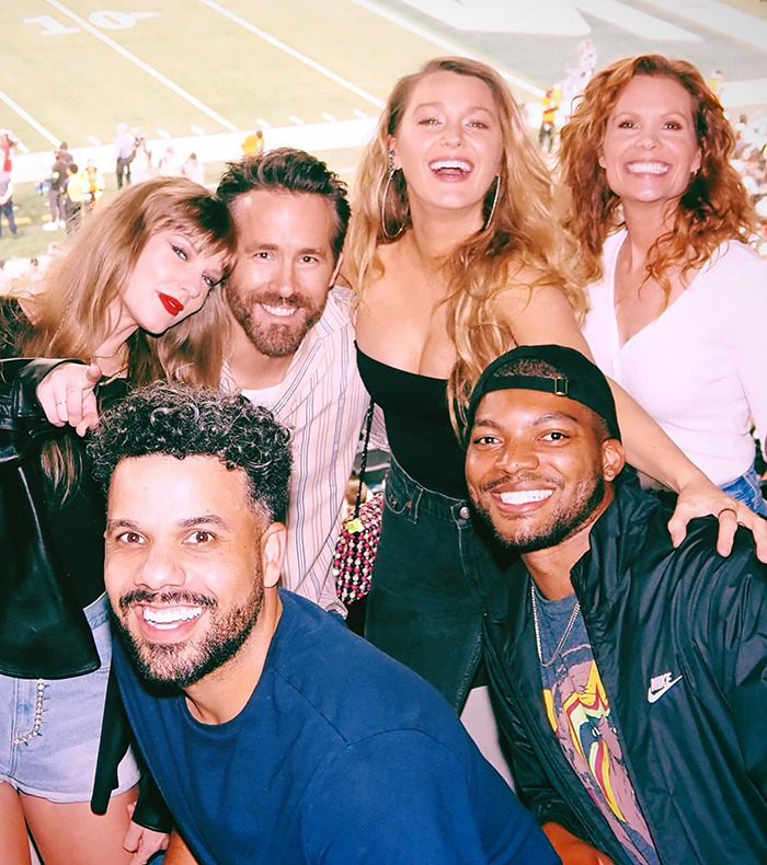 Taylor Swift, Blake Lively, and Ryan Reynolds poses with friends at a stadium, capturing a joyful moment in a lively atmosphere. Taylor Swift, Blake Lively, and Ryan Reynolds poses with friends at a stadium, capturing a joyful moment in a lively atmosphere.