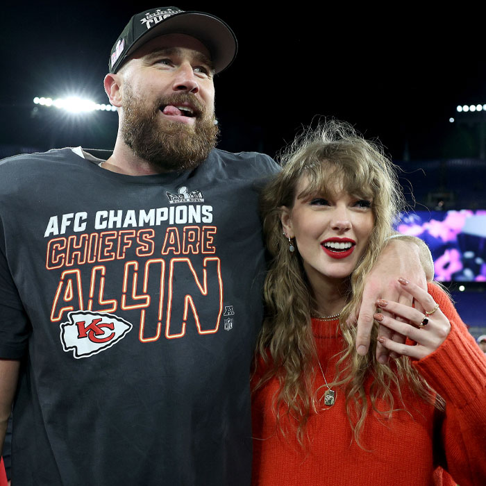 Couple laughing, one in a Chiefs shirt and the other in a red sweater, at a sports event. Couple laughing, one in a Chiefs shirt and the other in a red sweater, at a sports event.