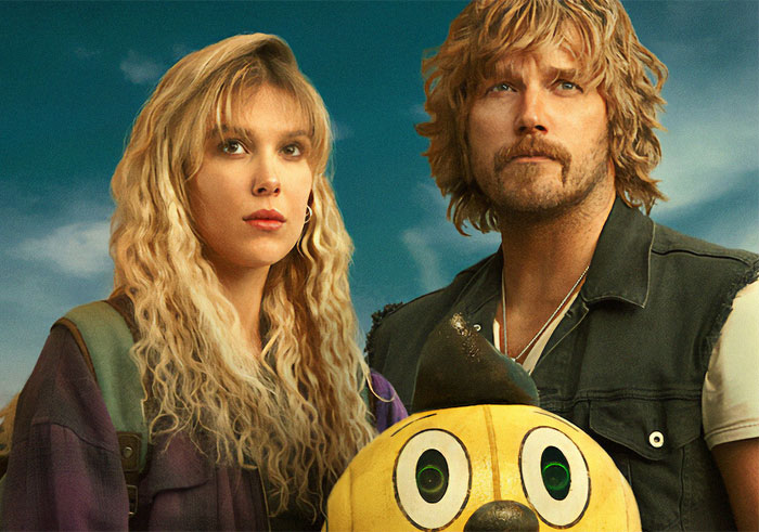 Millie Bobby Brown and Chris Pratt posing on the Electric State movie poster Millie Bobby Brown and Chris Pratt posing on the Electric State movie poster