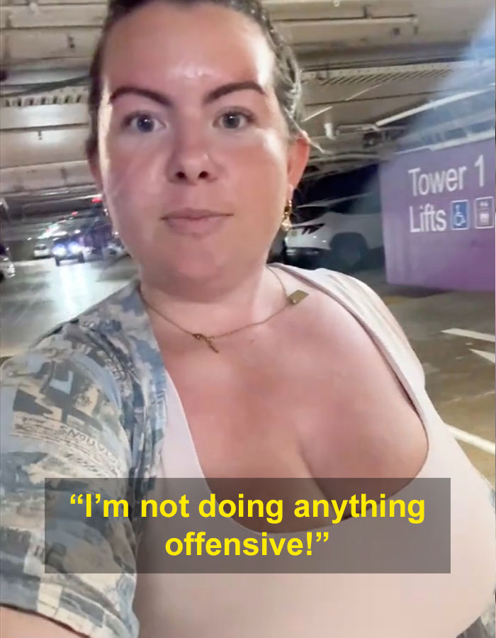 Woman with G-cup responding to stares in a parking structure, text overlay saying “I’m not doing anything offensive!” Woman with G-cup responding to stares in a parking structure, text overlay saying “I’m not doing anything offensive!”