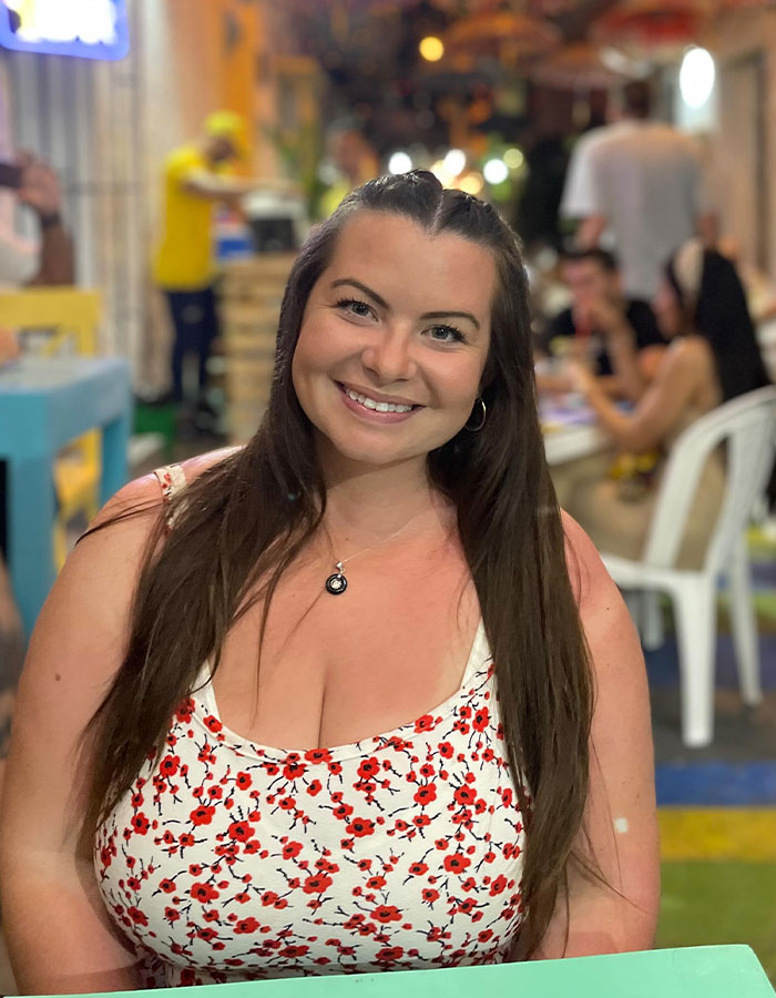 Woman smiling in a floral dress, addressing attention from strangers. Woman smiling in a floral dress, addressing attention from strangers.