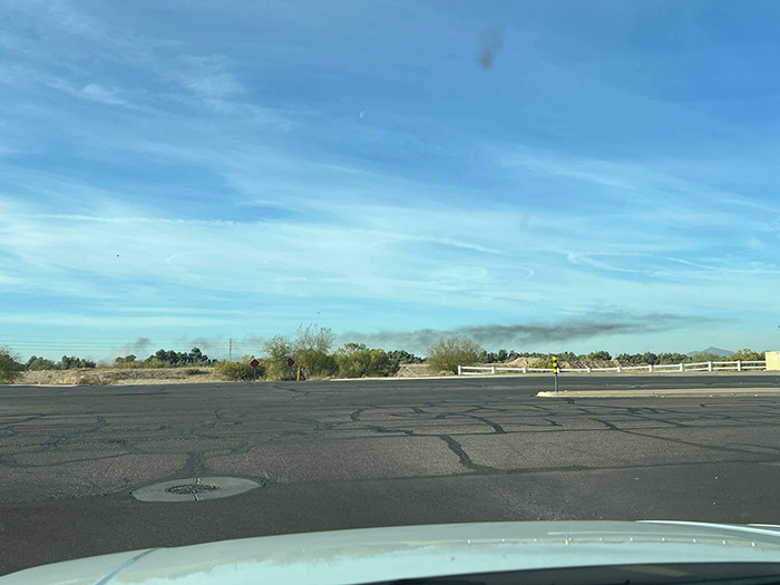 Smoke in Arizona sky after two planes collide mid-air, viewed from car windshield. Smoke in Arizona sky after two planes collide mid-air, viewed from car windshield.