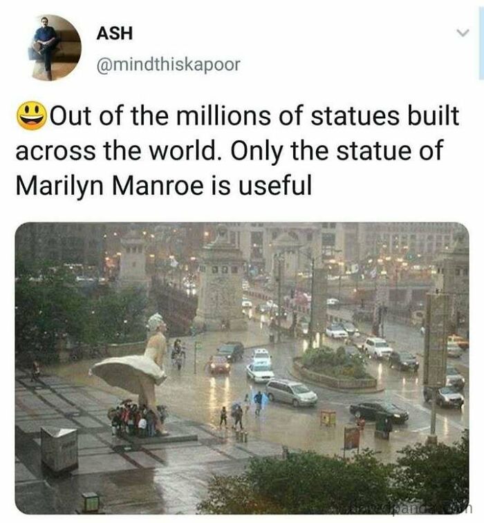 Statue of Marilyn Monroe used as shelter during rain, highlighting the funny and random meme context.
